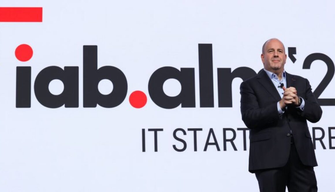 David Cohen, president and CEO of the Interactive Advertising Bureau, speaks on stage in front of an IAB logo during the group’s annual leadership meeting