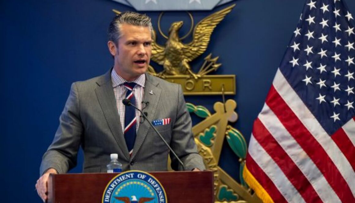 U.S. Secretary of War Pete Hegseth speaks at a podium with the Department of Defense seal during a briefing at the Pentagon.