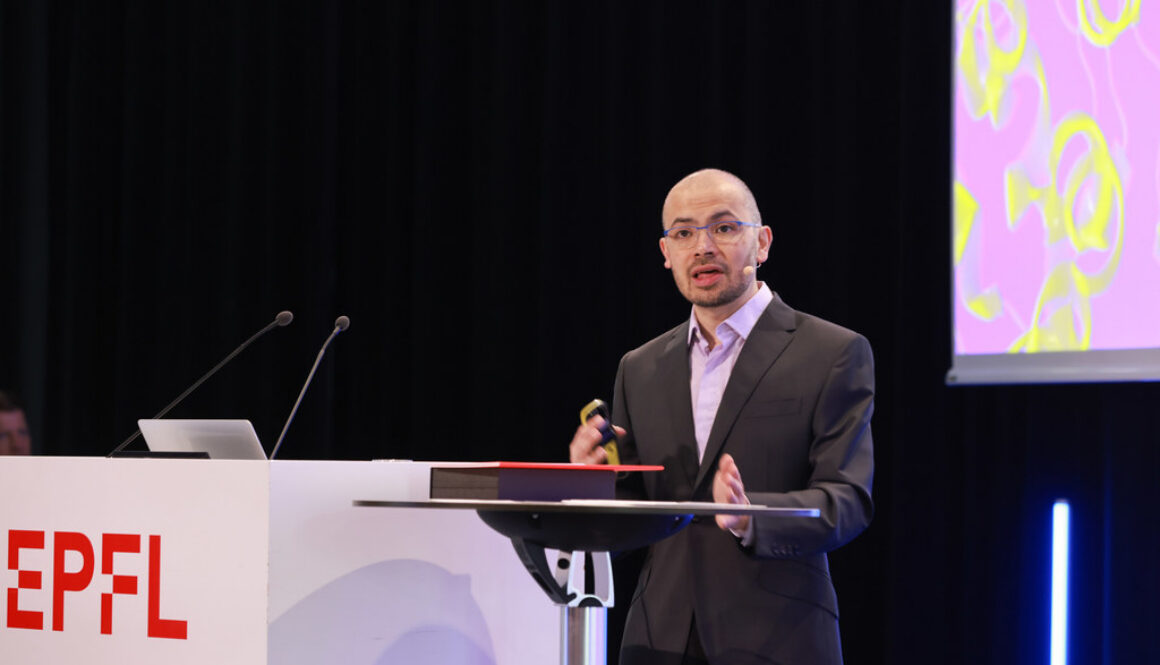 Demis Hassabis speaking at an event, accompanying coverage of his proposal for a U.S. AI watchdog.