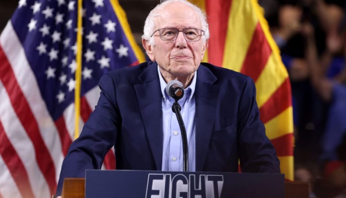 Sen. Bernie Sanders at a rally podium in 2025; his new bill would ban artificial superintelligence and pause powerful AI